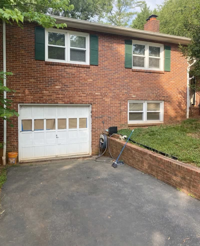 Before: the worn single door on a brick home